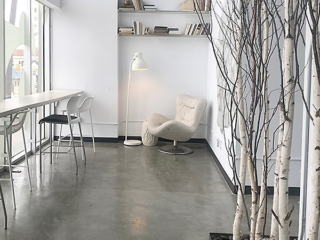 Concrete floor with easy chair by windows
